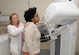 Wendy Elvis, 633rd Surgical Operations Squadron lead mammography technician, demonstrates the use of a mammogram machine with Melissa McRae, 633rd Surgical Operations Squadron command secretary, at Joint Base Langley-Eustis, Va., Oct. 17, 2016. Mammograms are recommended for women over the age of 40 and those whose family has a history of breast cancer. (U.S. Air Force photo by Staff Sgt. Teresa J. Cleveland)