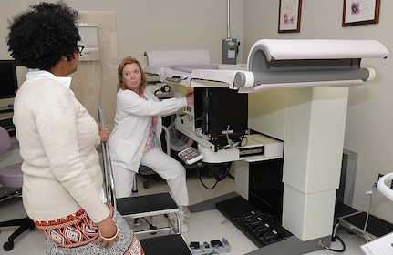 Wendy Elvis, 633rd Surgical Operations Squadron lead mammography technician, explains to Melissa McRae, 633rd Surgical Operations Squadron command secretary, how a breast biopsy machine is used at Joint Base Langley-Eustis, Va., Oct. 17, 2016. A patient may need a breast biopsy if a patient’s mammogram showed more testing is required, due to lesions in the breast which can be as small as a grain of sand. (U.S. Air Force photo by Staff Sgt. Teresa J. Cleveland)