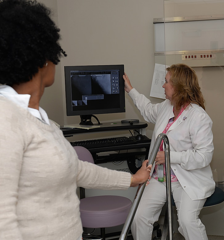 Wendy Elvis, 633rd Surgical Operations Squadron lead mammography technician, shows what is seen during a breast biopsy to Melissa McRae, 633rd Surgical Operations Squadron command secretary, at Joint Base Langley-Eustis, Va., Oct. 17, 2016. JBLE’s Women’s Health Clinics and Mammography Departments recommend women avoid putting off mammograms and regular women’s health appointments because early detection is the best way to increase a patient’s survival rate if they are diagnosed with breast cancer. (U.S. Air Force photo by Staff Sgt. Teresa J. Cleveland)