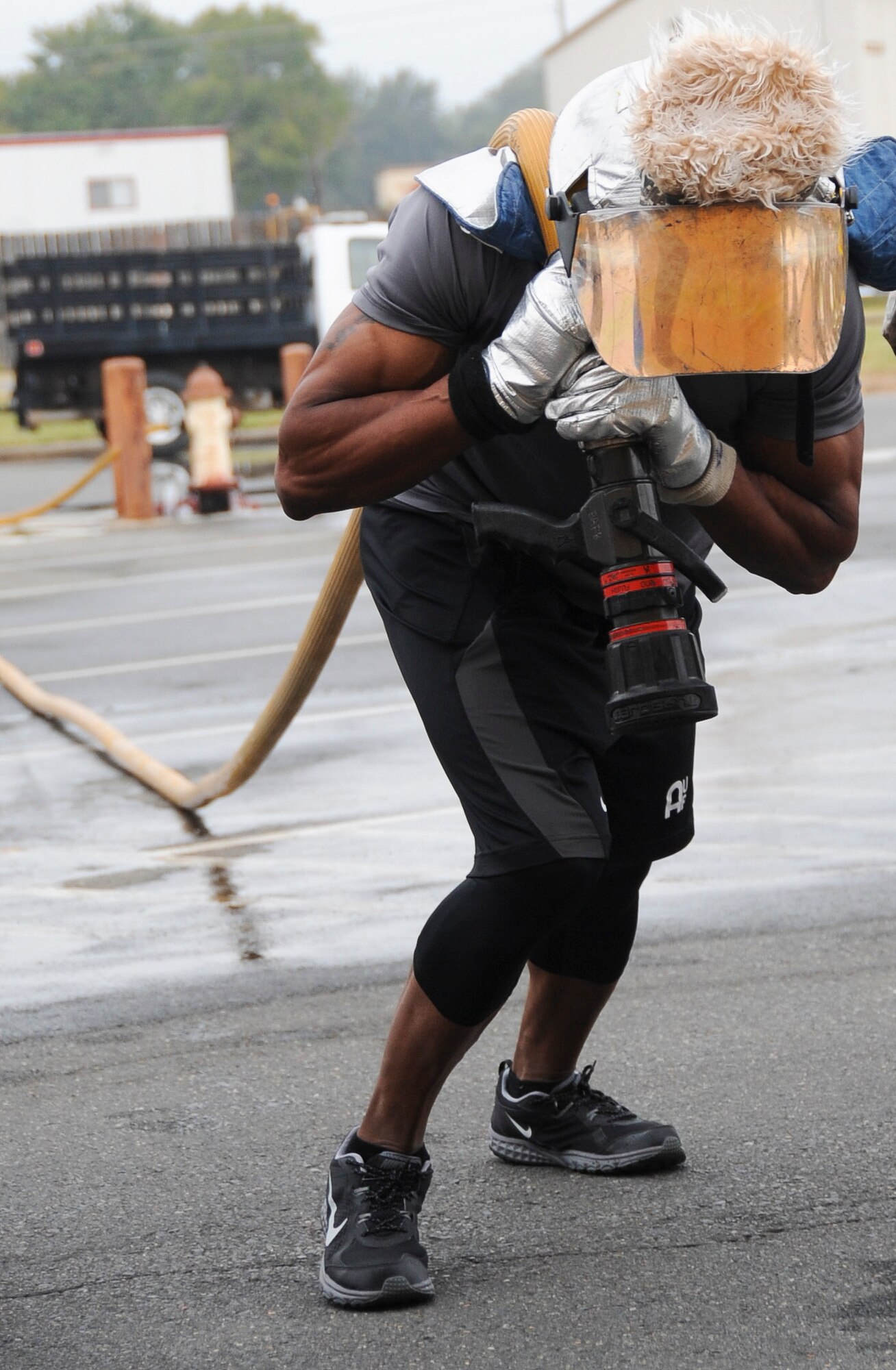 An Airman rushes to the finish line during a fire muster competition at Barksdale Air Force Base, La., Oct. 13, 2016. Each group of Airmen could choose to participate in different obstacles to mimic firefighter duties in honor of National Fire Prevention Week. (U.S. Air Force photo/Airman Alexis C. Schultz)