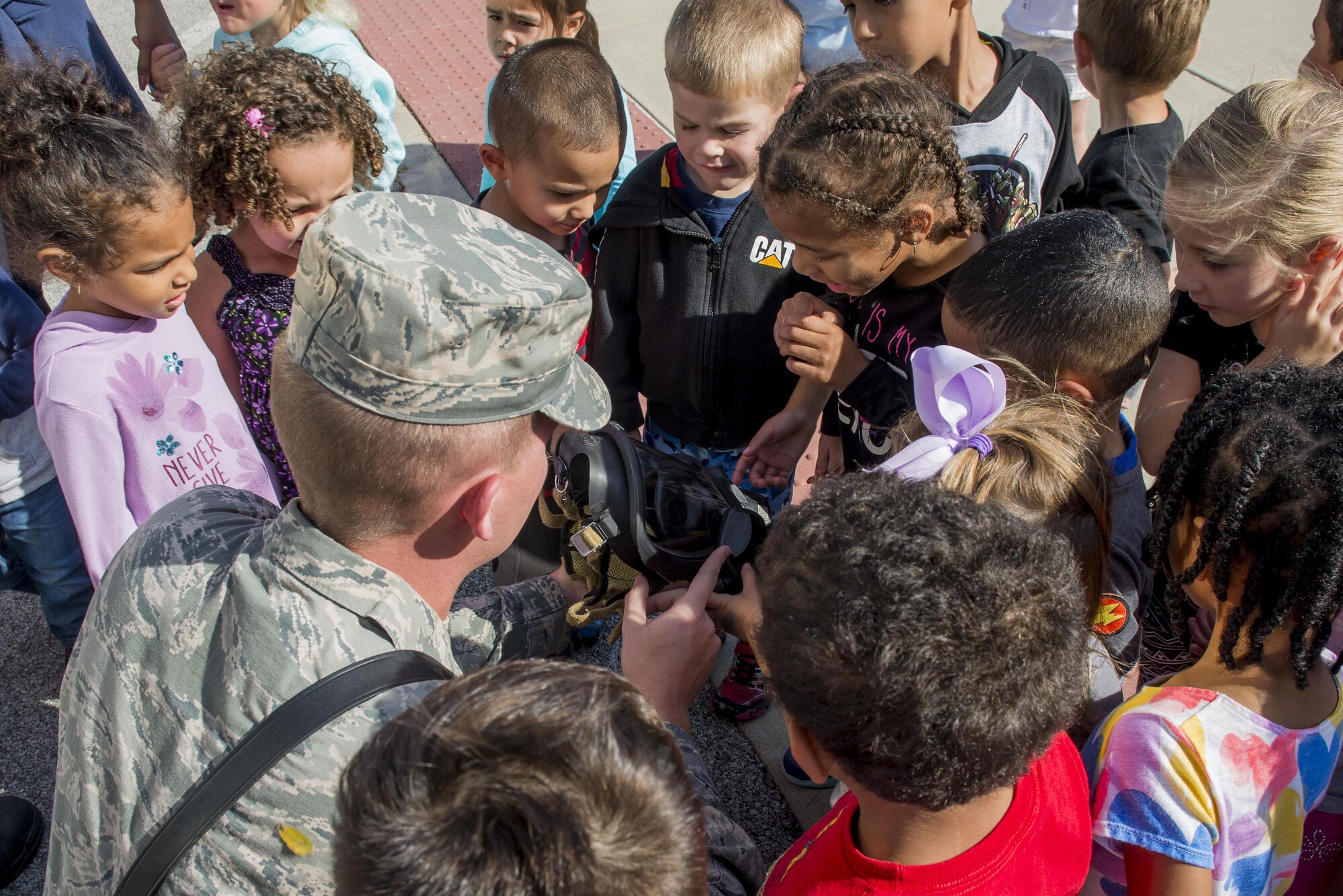 Senior Airman Tyler Startt, 375th Civil Engineering Squadron firefighter, shows the masks firefighters wear when responding to fires at a demonstration for children at the Child Development Center during fire prevention week, October 11, 2016 at the Child Development Center. This year’s Fire Prevention Week campaign, “Don’t Wait – Check the Date! Replace Smoke Alarms Every 10 Years,” represents the final year of our three-year effort to educate the public about basic but essential elements of smoke alarm safety. (U.S. Air Force photo by Senior Airman Joshua Eikren)