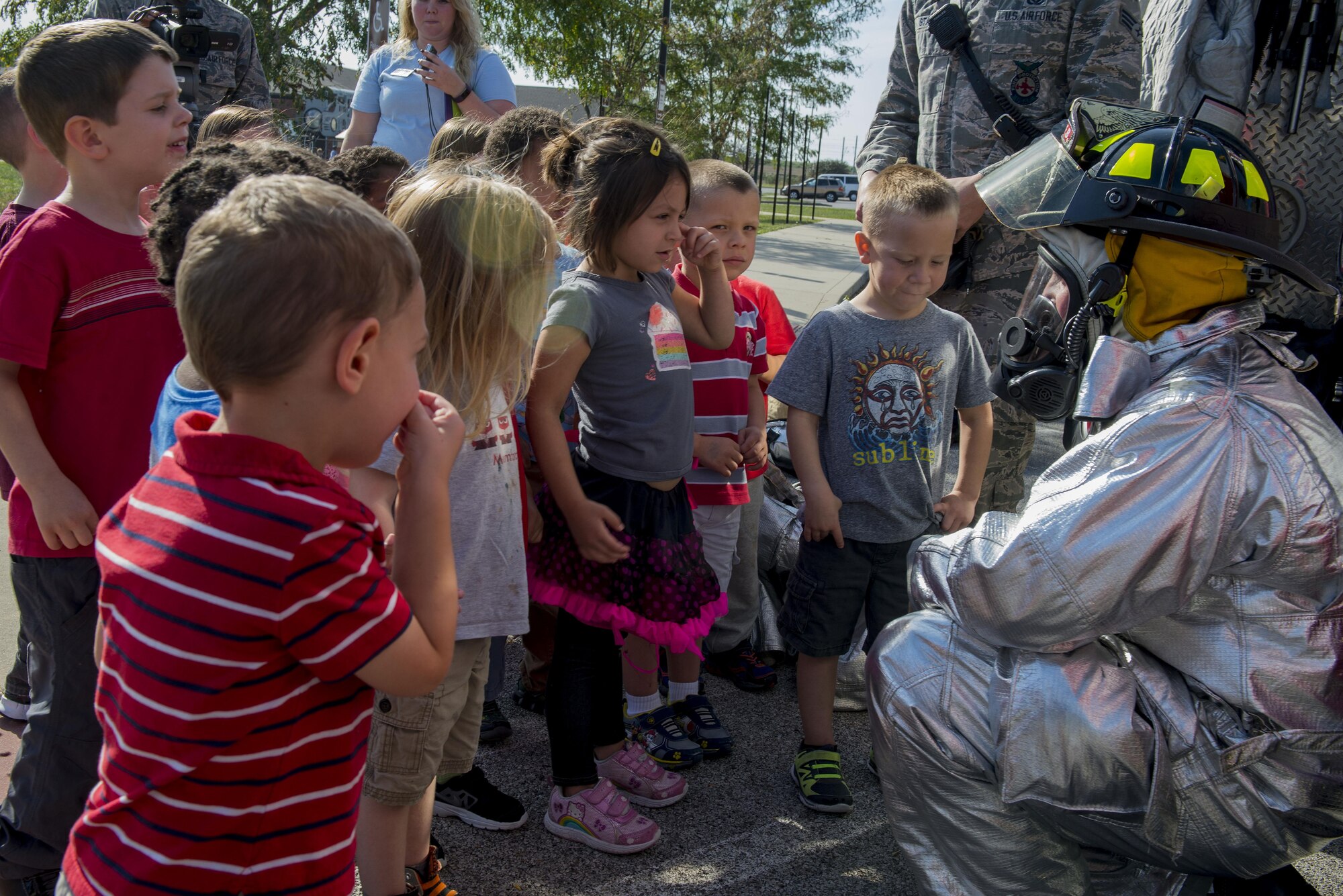Airman Patrick McLoughlin, 375th Civil Engineering Squadron firefighter, shows a fire suit to children to familiarize kids with the appearance of firefighters during fire prevention week, October 11, 2016 at the Child Development Center. This year’s Fire Prevention Week campaign, “Don’t Wait – Check the Date! Replace Smoke Alarms Every 10 Years,” represents the final year of our three-year effort to educate the public about basic but essential elements of smoke alarm safety. (U.S. Air Force photo by Senior Airman Joshua Eikren)