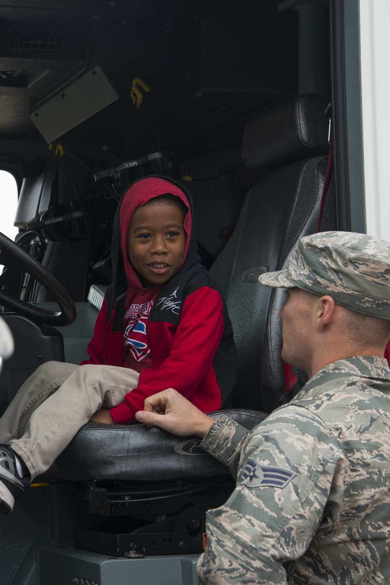 Senior Airman Tyler Moorehead, 375th Civil Engineering Squadron firefighter, shows a child the inside of a fire truck during fire prevention week, October 14, 2016 at the Child Development Center.This year’s Fire Prevention Week campaign, “Don’t Wait – Check the Date! Replace Smoke Alarms Every 10 Years,” represents the final year of our three-year effort to educate the public about basic but essential elements of smoke alarm safety.(U.S. Air Force photo by Airman Gwendalyn Smith)