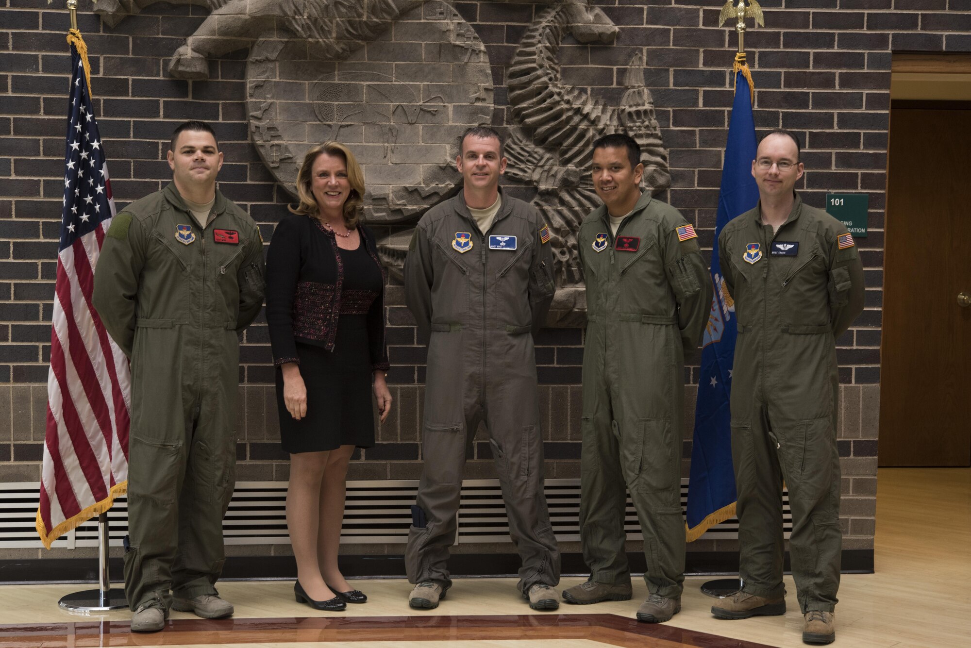 Secretary of the Air Force Deborah Lee James poses with the first four Enlisted Pilot Initial Class students in the U.S. Air Force Initial Flight Training School at Pueblo Memorial Airport in Pueblo, Colorado Oct. 17.  The Air Force announced the initiative to integrate the enlisted force into Remotely Piloted Aircraft flying operations as pilots Dec. 17, 2015 starting with the RQ-4 Global Hawk. Name badges were blurred due to Air Force limits on disclosure of identifying information for RPA operators. (U.S. Air Force photo illustration by Randy Martin)