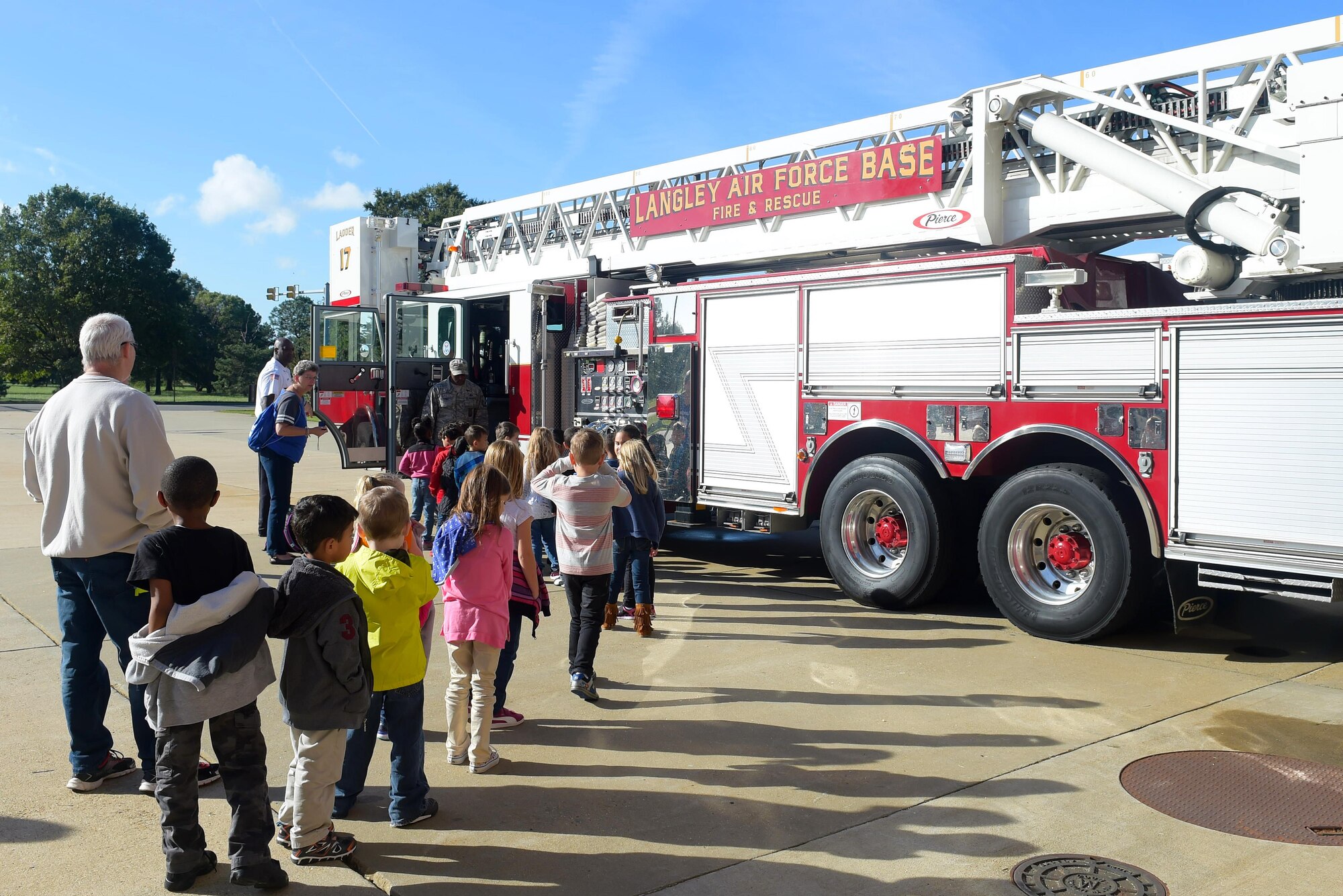 Students from Samuel P. Langley Elementary School, Hampton Va., stand in line to look at the inside of a firetruck at Joint Base Langley-Eustis, Va., Oct. 12, 2016. Each student had the opportunity to sit inside of the truck and learn more about what fire fighters do. (U.S. Air Force photo by Senior Airman Kimberly Nagle)