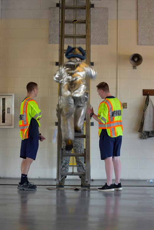 A participant of the Combat Challenge climbs a ladder at Joint Base Langley-Eustis, Va., Oct. 14, 2016. More than 10 teams participated in the several station event that tested their strength and firefighting abilities. (U.S. Air Force photo by Senior Airman Kimberly Nagle) 