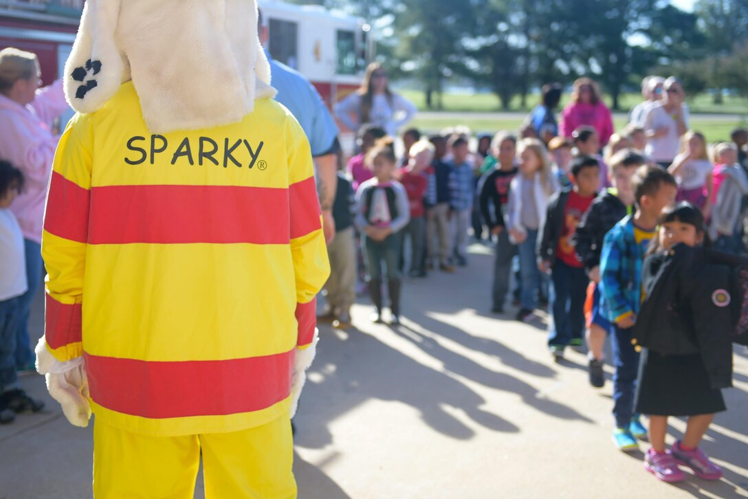 “Sparky” the Firedog greets students from Samuel P. Langley Elementary School, Hampton Va., before their tour at of the Langley Air Force Base fire department at Joint Base Langley-Eustis, Va., Oct. 12, 2016. In addition to touring the department, students learned how firefighters put on their protective gear. (U.S. Air Force photo by Senior Airman Kimberly Nagle)