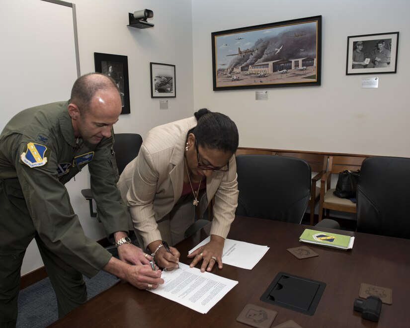 Col. E. John Teichert, 11th Wing and Joint Base Andrews commander, and Ramona Hawkins, JBA American Federation of Government Employees 1401 president, sign a Labor-Management Forum Charter Oct. 11, 2016. The charter was signed to signify the establishment of a cooperative and productive forum between labor and management relations by discussing workplace challenges on a regular basis. (U.S. Air Force photo by Senior Airman Philip Bryant)