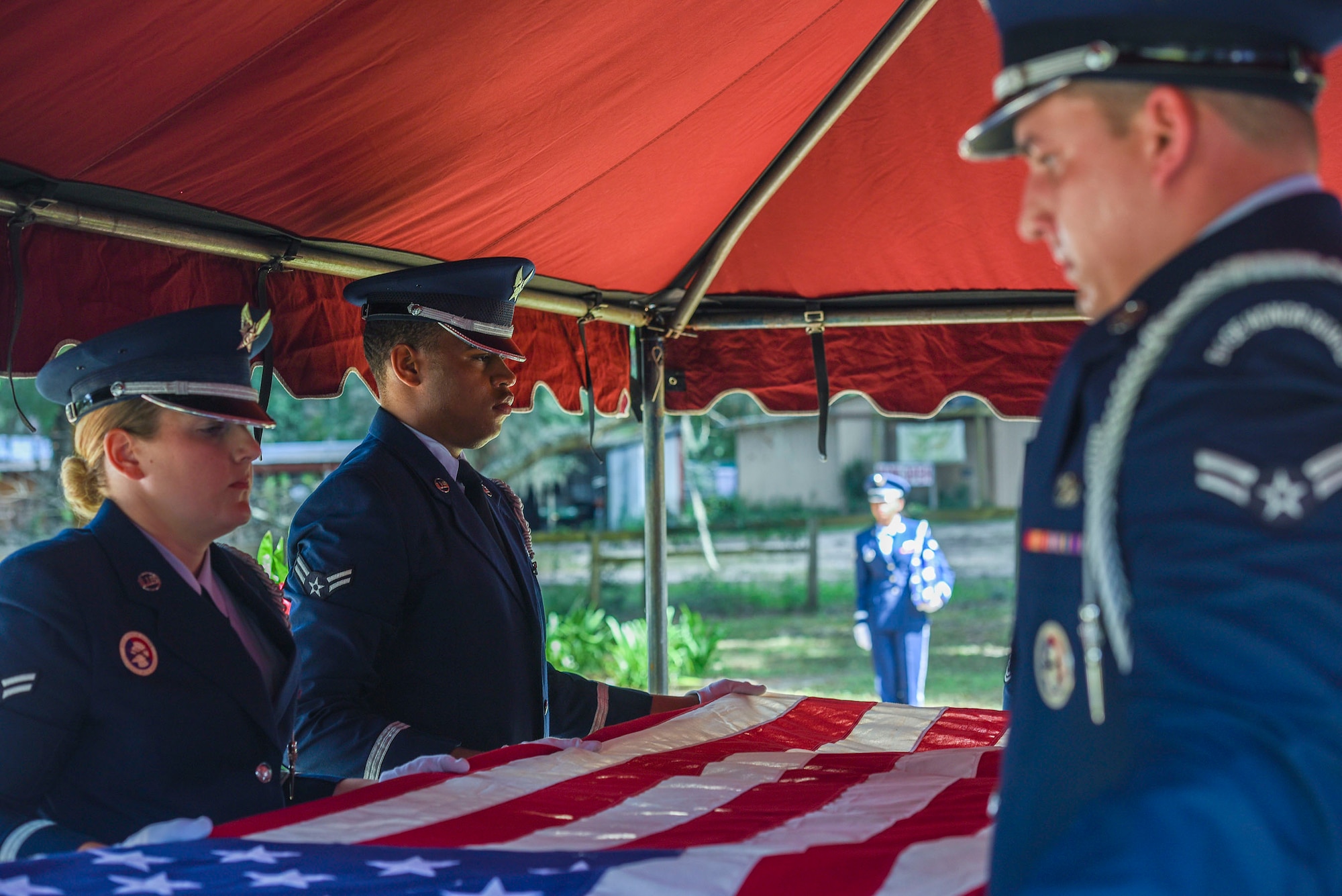 Members of the Moody Air Force Base Honor Guard, prepare to fold a flag during a funeral in honor of  Staff Sgt. Darryl Smith, Oct. 17, 2016, in Sparr, Fla. Smith was a laboratory technician assigned to the 509th Medical Support Squadron, Whiteman Air Force Base, Mo., who passed away in his home, Oct. 8. (U.S. Air Force photo by Airman 1st Class Greg Nash)