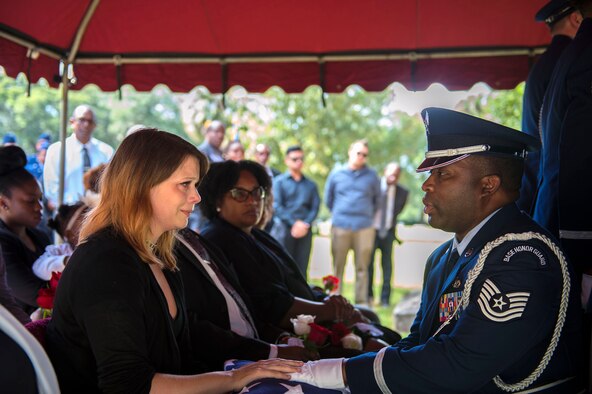 Albessa Smith, widow of the late Staff Sgt. Darryl Smith, 509th Medical Support Squadron laboratory technician, Whiteman Air Force Base, Mo., receives a flag in her husband’s honor from Tech. Sgt. Forris Phillips, 23d Wing NCO in charge of honor guard, Oct. 17, 2016, in Sparr, Fla. The couple met as Airmen during technical training at Fort Sam Houston, Texas and married in 2012 in Houston, Texas while Albessa was stationed at Elmendorf AFB, Alaska and Darryl was completing training at Keesler AFB, Miss. (U.S. Air Force photo by Airman 1st Class Greg Nash)