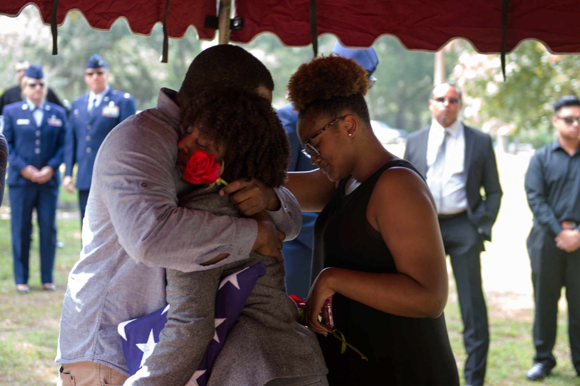 Senior Airman Jasmine Smith, 23d Equipment Maintenance Squadron HC-130J Combat King II aerospace propulsion journeyman, middle, embraces her siblings Ken and Deja, during their brother’s funeral, Oct. 17, 2016, in Sparr, Fla. SrA Smith decided to follow in Staff Sgt. Darryl Smith’s, 509th Medical Support Squadron laboratory technician, Whiteman Air Force Base, Mo., footsteps and joined the Air Force in 2014, after he enlisted in 2011.