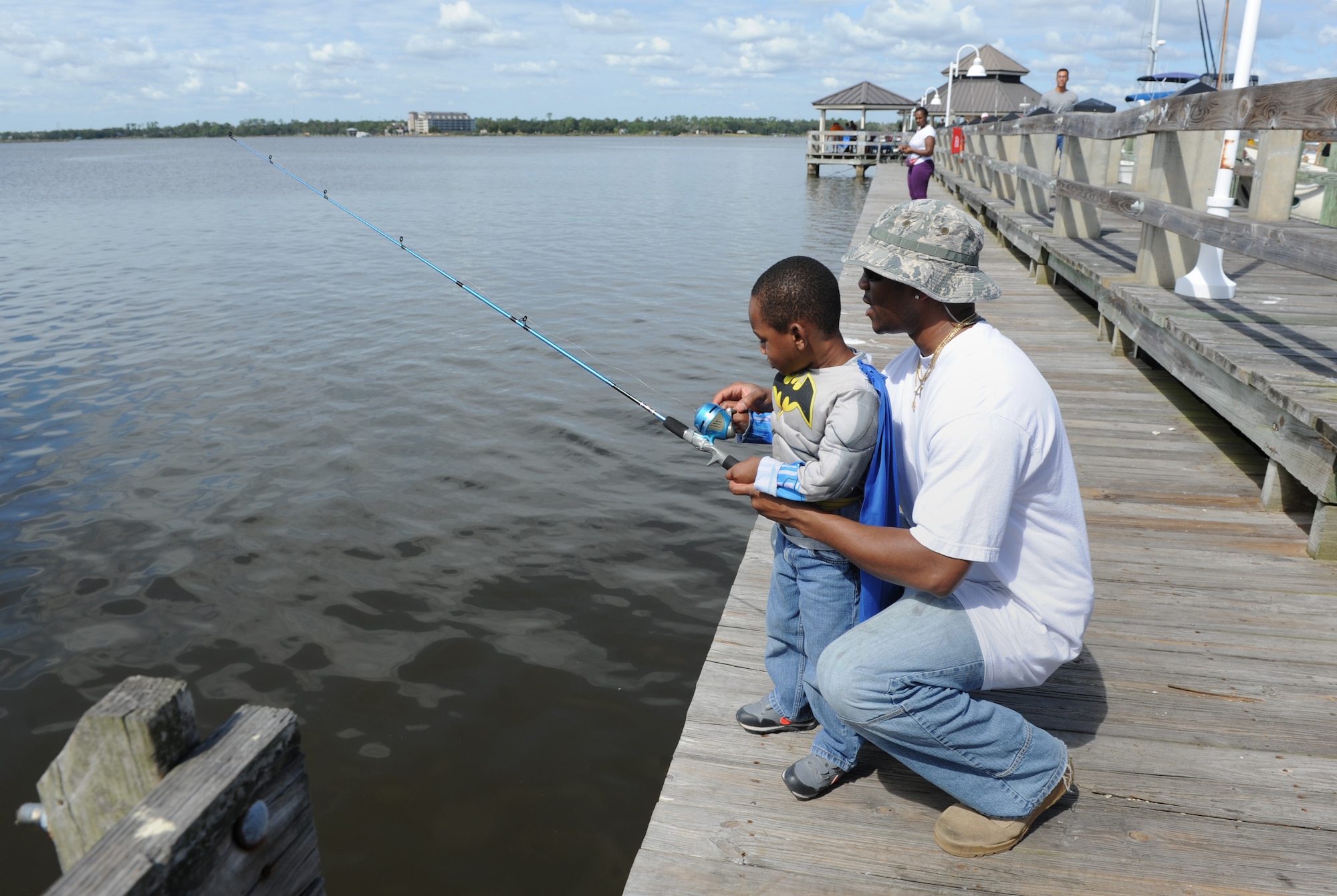Staff Sgt. Edward Burden, 366th Training Squadron, Detachment 6, structural instructor, Naval Construction Battalion Center, Gulfport, Miss., and his son, Kaden, cast their bait out into the Biloxi Back Bay during the Kids’ Fishing Rodeo at the marina Oct. 15, 2016, on Keesler Air Force Base, Miss. Over 90 participants attended the event where prizes were awarded for different categories and free food was available. (U.S. Air Force photo by Kemberly Groue/Released)