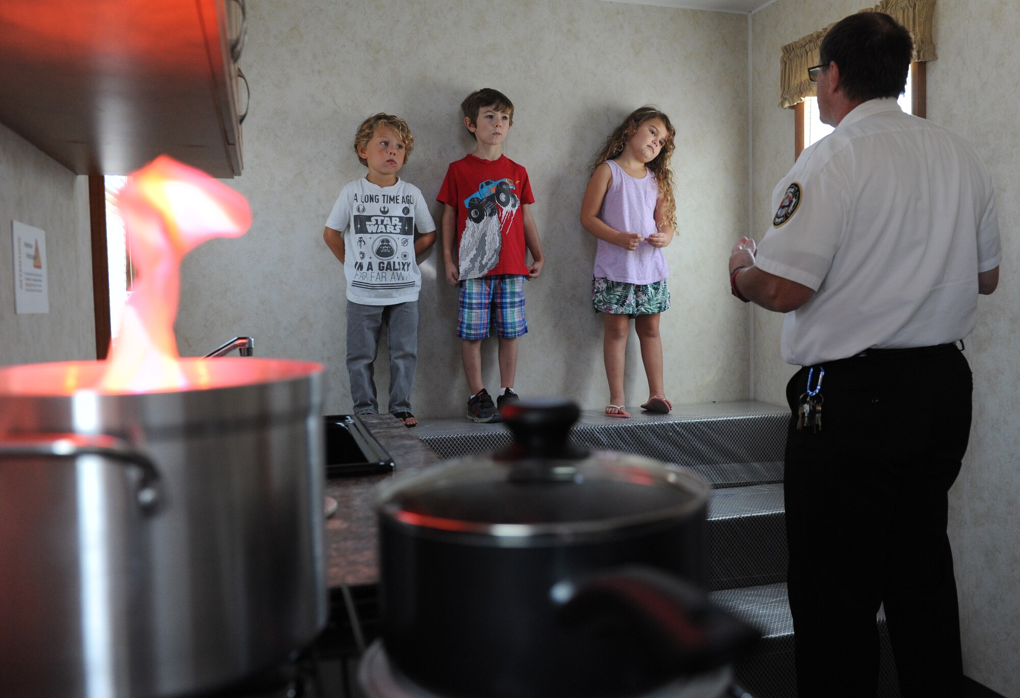 James Shirah, 81st Infrastructure Division fire inspector, shows Keesler children what to do when smoke fills a room during the Fire Prevention Week open house at the Keesler Fire Department Oct. 15, 2016, on Keesler Air Force Base, Miss. Throughout the week the Keesler Fire Department conducted fire drills, toured various facilities with Sparky the Fire Dog, passed out fire safety information and fire hats for children and provided stove and fire extinguisher demonstrations. (U.S. Air Force photo by Kemberly Groue/Released)