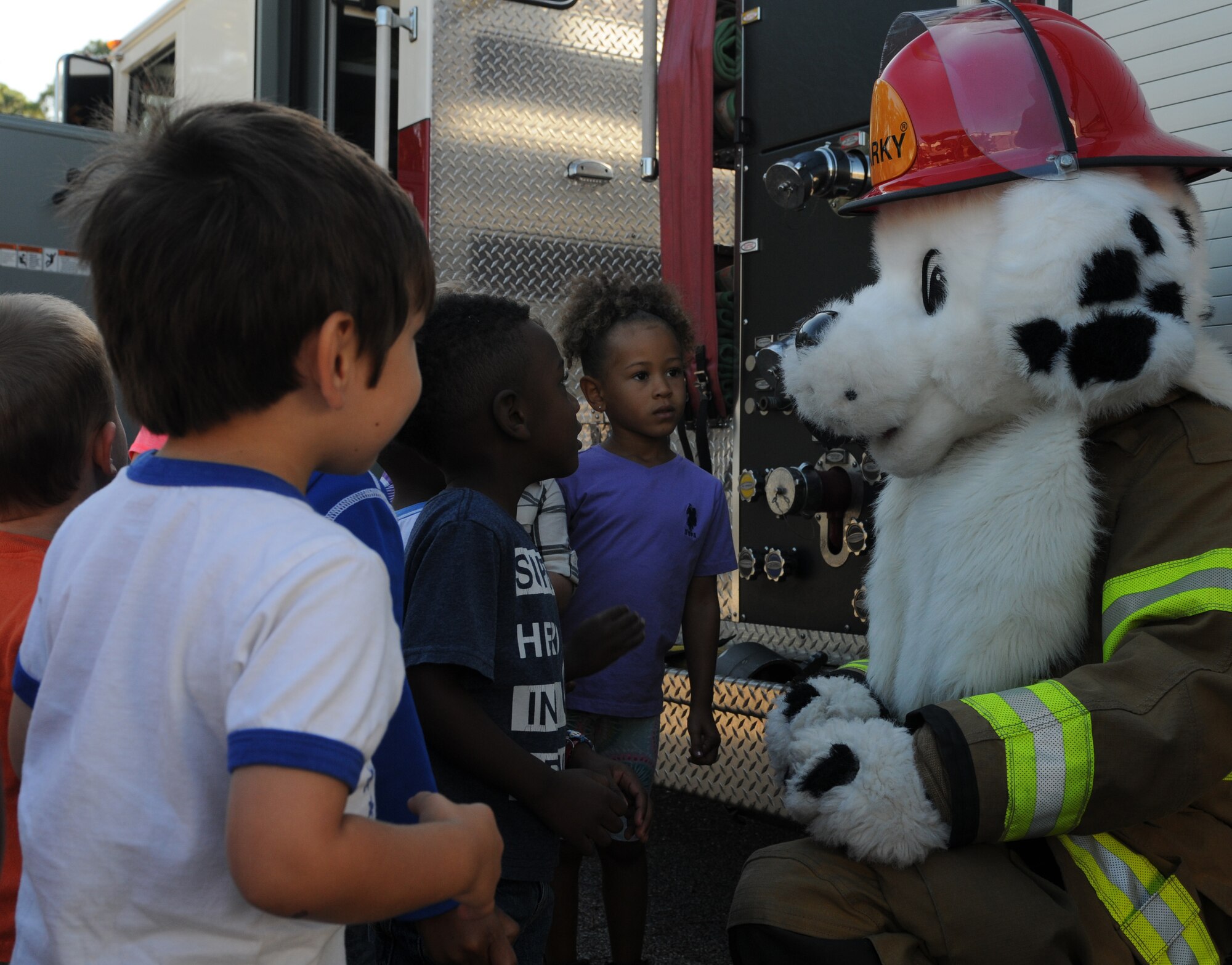 Keesler Child Development Center children meet Sparky the Fire Dog during a Fire Prevention Week demonstration at the CDC Oct. 12, 2016, on Keesler Air Force Base, Miss. The week-long event included fire drills, literature hand-outs and stove fire demonstrations around the base and concluded with an open house at the fire department. (U.S. Air Force photo by Senior Airman Holly Mansfield/Released)