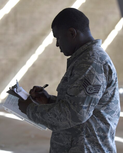 Staff Sgt. Justin Stanley, 2nd Security Forces Squadron combat arms instructor, records the results of the M9 Berretta qualification shoot at Barksdale Air Force Base, La., Oct. 17, 2016. The M9 was fired at targets that were seven, 15 and 25 meters away. (U.S. Air Force photo/Airman 1st Class Stuart Bright)