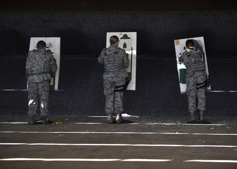 Security Forces members set up targets for M4 carbine qualification at Barksdale Air Force Base, La., Oct. 17, 2016. The target for the M4 was placed 25 meters away but was simulated at 75 meters, 175 meters and 300 meters. (U.S. Air Force photo/Airman 1st Class Stuart Bright)