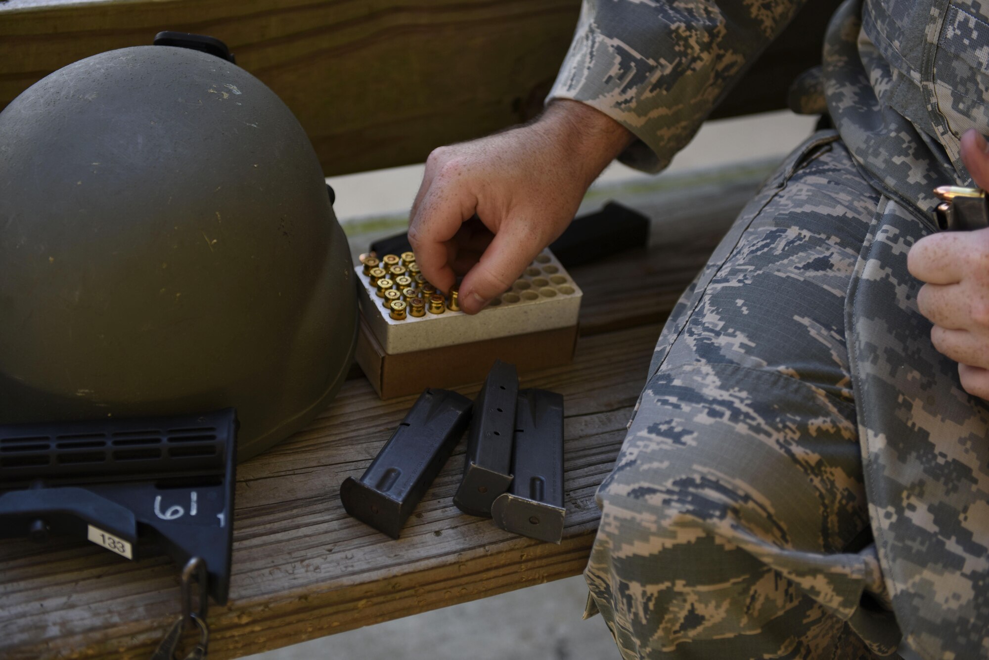 Staff Sgt. Joshua Begley, 2nd Security Forces Squadron Alpha Flight Chief, reaches for ammunition to load his M9 Berretta at Barksdale Air Force Base, La., Oct. 17, 2016. The M9 uses 9 mm ammunition and has an effective range of 50 meters. (carry both every day on patrol) (U.S. Air Force photo/Airman 1st Class Stuart Bright)