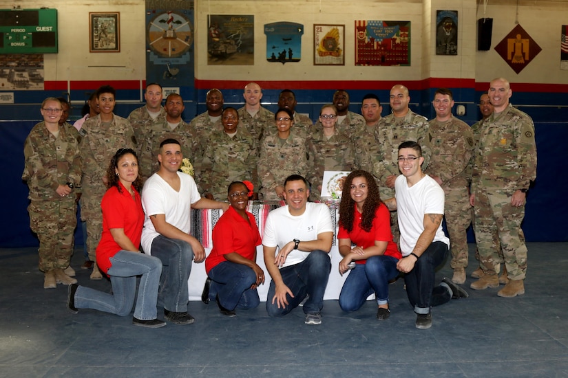 Volunteers for the Hispanic Heritage Month observance at Camp Arifjan, Kuwait pose for a picture after the event October 1. The observance consisted of a panel made up of Hispanic service members from a range of duties and roles, a dance showcase, several tables set up with information and treats from different Latin American countries and a piñata, to name a few. (U.S. Army photo by Sgt. Jonathan Fernandez)