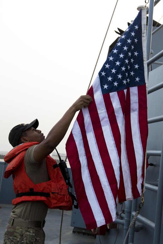 Sgt. Malcom Hilbert, a food service specialist from the 411th Transportation Detachment and a Tupelo, Miss. resident, raised the flag on the MG Charles P. Gross (Logistics Support Vessel-5) during a range exercise in the Arabian Gulf, October 3, 2016. The ship supports the U.S. Army Central mission to move cargo and large vehicles throughout the Middle East from Kuwait Naval Base. (U.S. Army photo by Sgt. Brandon Hubbard, USARCENT Public Affairs)
