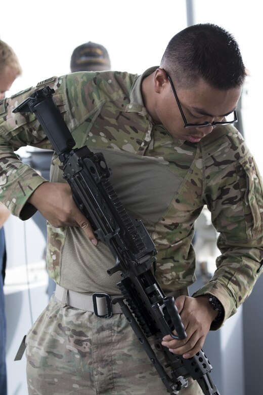 Pfc. Bunnath Chhun, from the 3rd Armored Brigade Combat Team, 1st Infantry Division and a Sheridan, Ind. native, inspects a M249 Squad Automatic Weapon before it is used for range training on the MG Charles P. Gross (Logistics Support Vessel-5) in the Arabian Gulf, October 3, 2016. The ship is part of the large logistics network U.S. Army Central uses to move vehicles and equipment throughout the Central Command theater. (U.S. Army photo by Sgt. Brandon Hubbard, USARCENT Public Affairs)