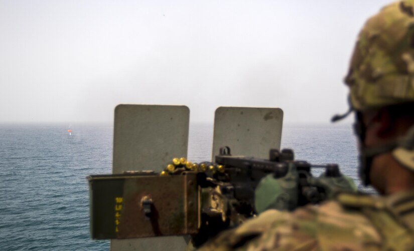 Pfc. Bunnath Chhun, from the 3rd Armored Brigade Combat Team, 1st Infantry Division and a Sheridan, Ind. Native, fires a .50 caliber machine gun at a “Killer Tomato” target from the MG Charles P. Gross (Logistics Support Vessel-5) in the Arabian Gulf, October 3, 2016. The ship is part of the large logistics network U.S. Army Central uses to move vehicles and equipment throughout the Central Command theater. (U.S. Army photo by Sgt. Brandon Hubbard, USARCENT Public Affairs)