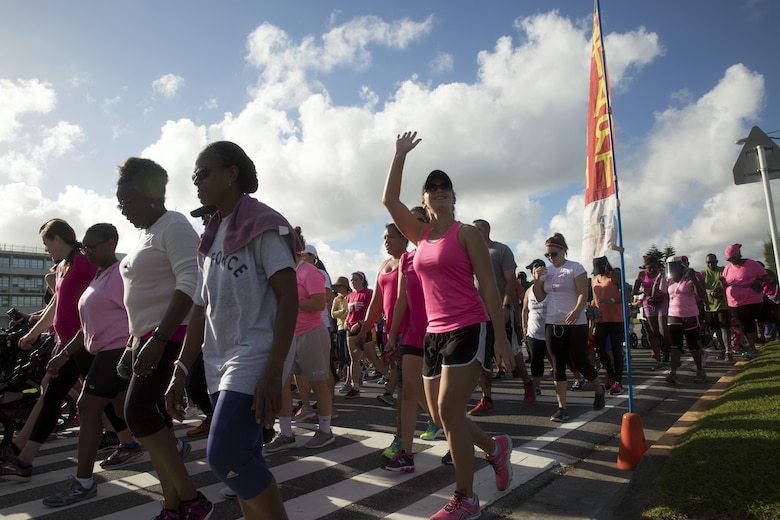 Participants cross the starting line for the Second Annual Breast Cancer Awareness 5-kilometer Run, Oct. 1 aboard Camp Lester, Okinawa, Japan. The event brought Status of Forces Agreement members together to show support for survivors of breast cancer. During the event, representatives from Marine Corps Community Services Health Promotion handed out information pamphlets on available support services for breast cancer survivors and their families. (U.S. Marine Corps photo by Cpl. Janessa K. Pon / Released)