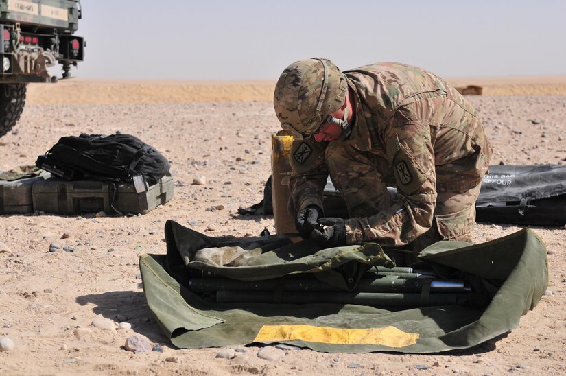 A multiple launch rocket system crewmember with 1st Battalion, 94th Field Artillery Regiment helps pack up the forward command post after completing during a decisive action training environment exercise on Oct. 4, 2016 near Camp Buehring, Kuwait. (U.S. Army photo by Sgt. Aaron Ellerman)