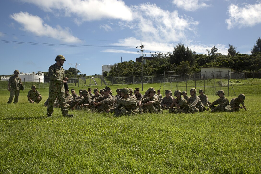 Japan Ground Self-Defense Force Sgt. Imato translates instructions prior to a patrolling exercise during the annual Guard and Protect, an observe and exchange event, Oct. 7 on Marine Corps Air Station Futenma, Okinawa, Japan. The three-day event sharpened U.S. and JGSDF service members’ abilities to defend installations through the observation and exchange of tactical procedures and operational concepts. The training included patrolling, rules of engagement and vehicle search and seizure procedures.