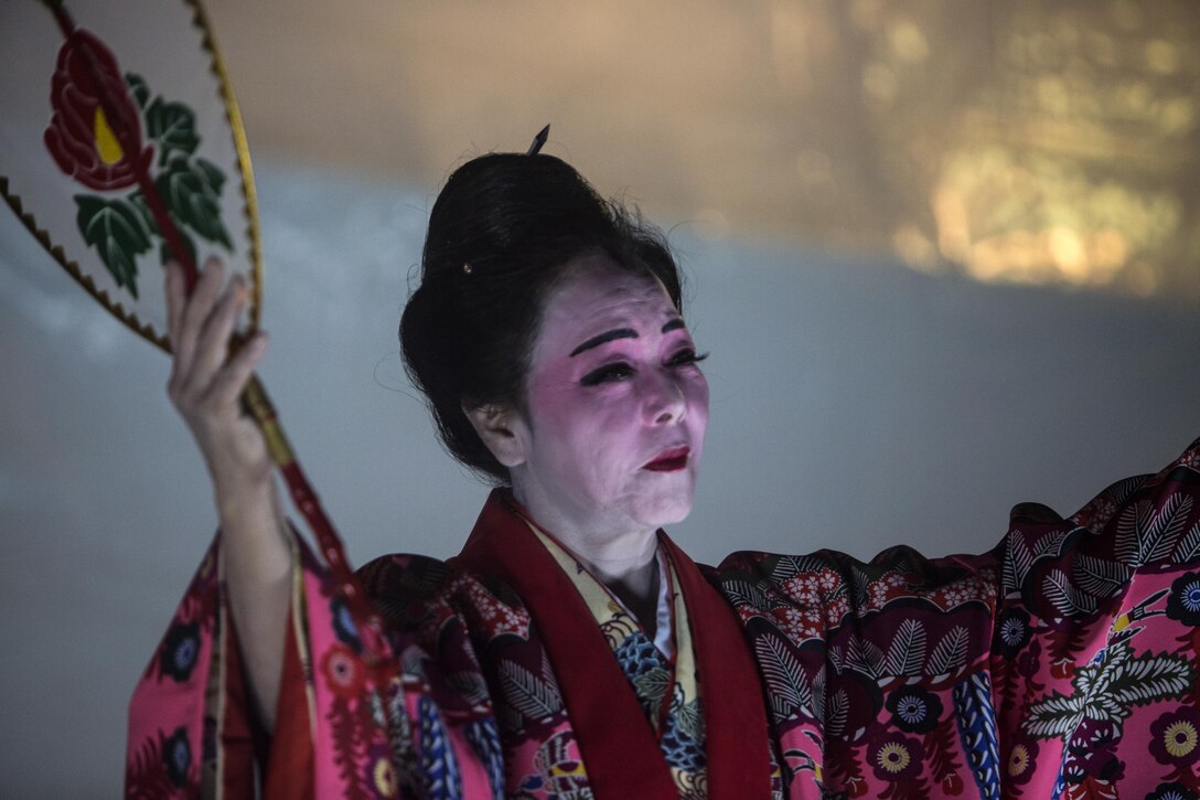 An Okinawan woman dances in traditional Ryukyuan style to welcome the viewing’s attendees at Mt. Ishikawa, Okinawa, Japan, October 15, 2016. The celebratory dance for the Moon Light Festivals was originally created as welcoming entertainment dance for the Chinese government. The dancers wear a kimono made from fabric dyed in the bingata style. (U.S. Marine Corps photo by Lance Cpl. Breanna Weisenberger / Released)