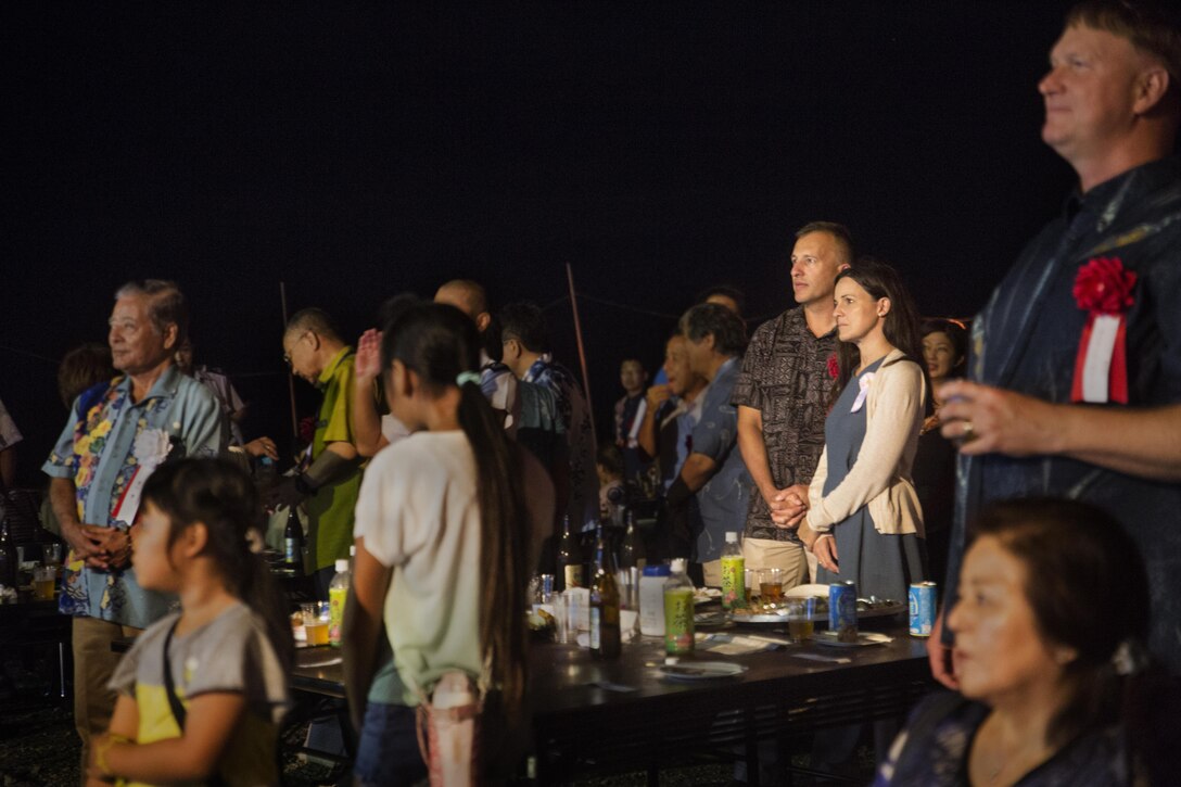 Col. Brian M. Howlett and his wife, Amanda, watch the South Western Air Band perform during the Moon Viewing Ceremony at Mt. Ishikawa, Okinawa, Japan, October 15, 2016. The Okinawan community gathers to celebrate the coming of fall by bonding with their neighbors. During the ceremony the attendees eat, dance and watch the full moon. Howlett, from Naples, Florida, is the camp commander for Camp Hansen. (U.S. Marine Corps photo by Lance Cpl. Breanna Weisenberger / Released)