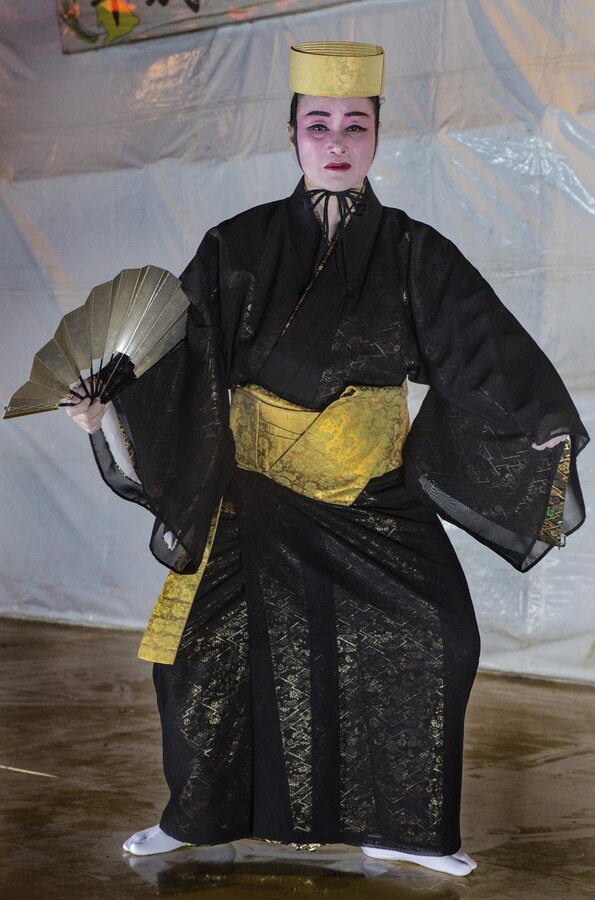 An Okinawan woman dances in traditional Ryukyuan style to welcome the viewing’s attendees at Mt. Ishikawa, Okinawa, Japan, October 15, 2016. The celebratory dance for the Moon Light Festivals was originally created as welcoming entertainment dance for the Chinese government. The dancers wear a kimono made from fabric dyed in the bingata style. (U.S. Marine Corps photo by Lance Cpl. Breanna Weisenberger / Released)