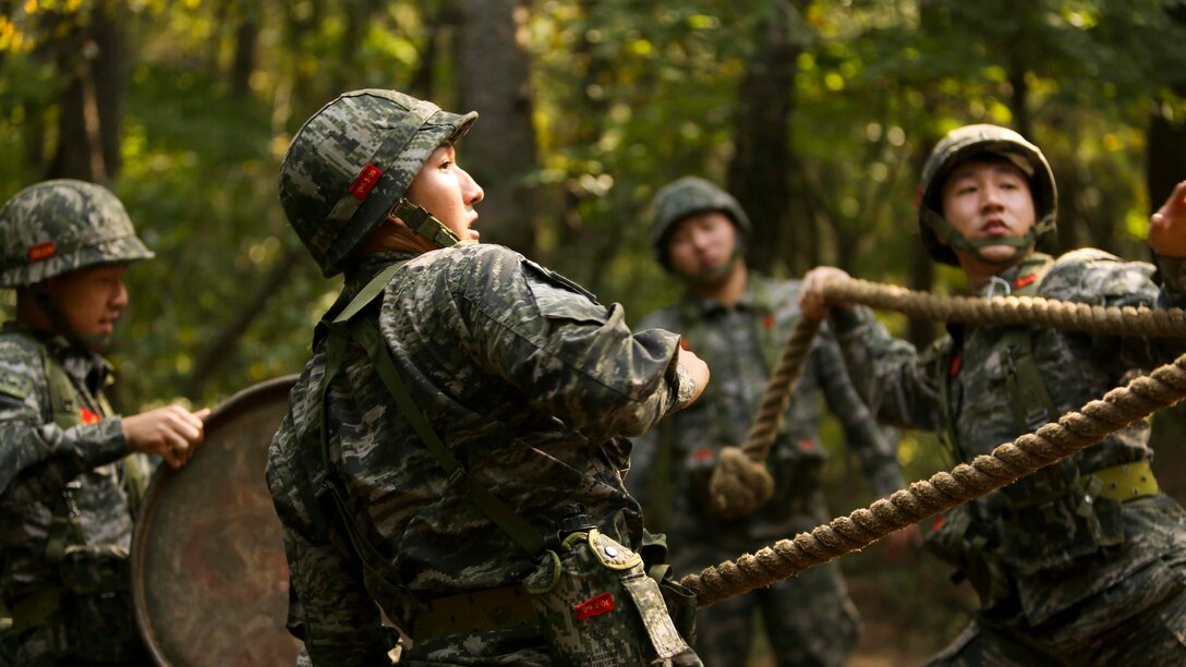 Republic of Korea Marines transport items over an obstacle using a rope during a bilateral leadership reaction course at Camp Mujuk, Republic of Korea, October 14, 2016. The LRC is a course designed to provide formal leadership instruction while teaching participants to work together as a team. The U.S. is committed to work further with our partner nations to nurture and deepen defense and bilateral engagements, including developing unique training opportunities between our armed forces.