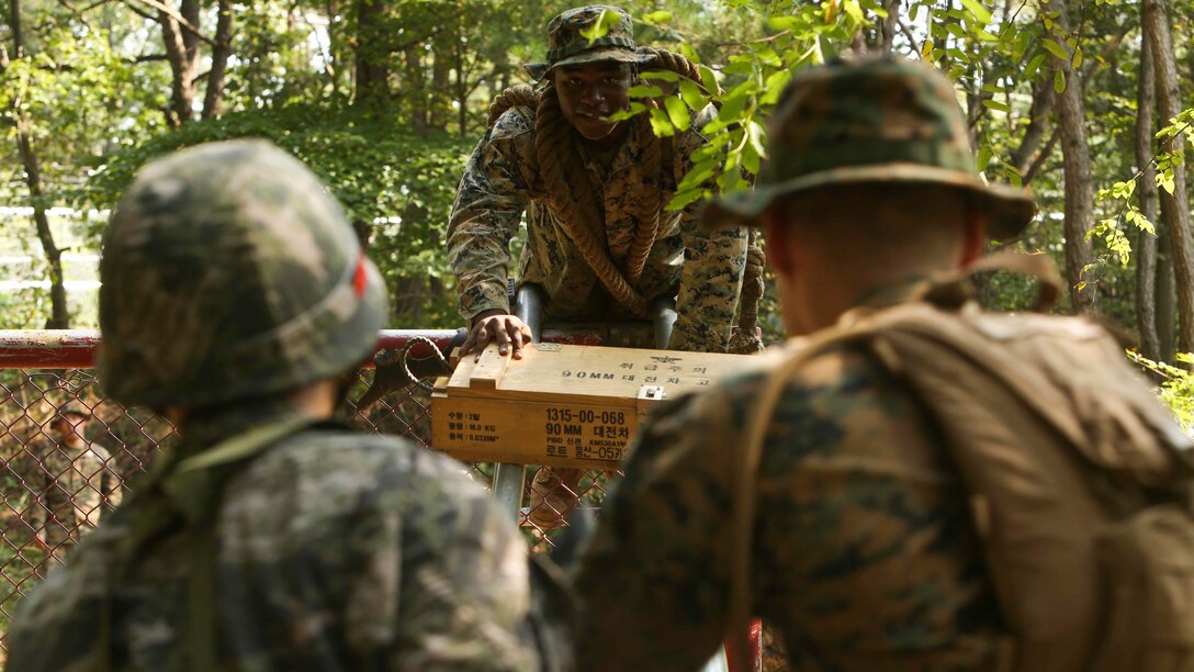Lance Cpl. Yishmael Henderson, a landing support specialist with Combat Logistics Regiment 3, 3d Marine Logistics Group, III Marine Expeditionary Force, slides an ammo crate down two metal poles during a bilateral leadership reaction course at Camp Mujuk, Republic of Korea, October 14, 2016. The LRC is a course designed to provide formal leadership instruction while teaching participants to work together as a team. The U.S. is committed to broadening and strengthening the robust ties it has with its partners in the Asia-Pacific region through bilateral training and engineering exercises.