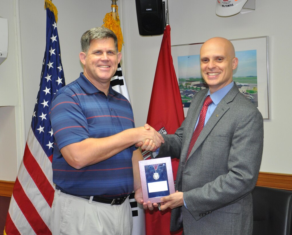 On Oct. 19 Richard Stump, Regional Vice President, Society of American Military Engineers (SAME), presented the SAME RVP Medal to the Far East District's Dr. Michael Neaverth (pictured left), The RVP Medal is in recognition for Dr. Neaverth's outstanding service to SAME as an active member for the Korea Post. Dr. Neaverth has supported the SAME within the Korea Post in various capacities to include webmaster, secretary, VP North and as a leader on various Korea post engineering related activities. Dr. Neaverth is currently serving Chief, Air Force, Business Process, and Reports Branch, Far East District, US Army Corp of Engineers.