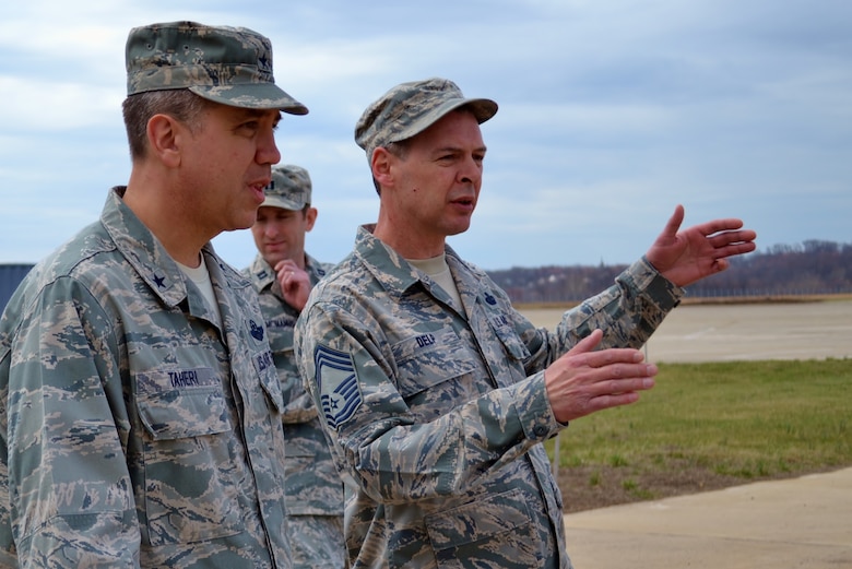 Chief Master Sgt. Harley Delp, 111th Communications Flight, speaks with Brig. Gen. Michael Taheri, Air National Guard Readiness Center commander, Joint Base Andrews, Md., while Capt. Timothy McManus, of the 111th Comptroller Flight, looks on during Taheri’s visit to Horsham Air Guard Station, Pa. March 12, 2016. Delp advocates for all Air National Guardsmen to continue to grow as professionals in their military careers. (U.S. Air National Guard photo by Tech. Sgt. Andria Allmond)