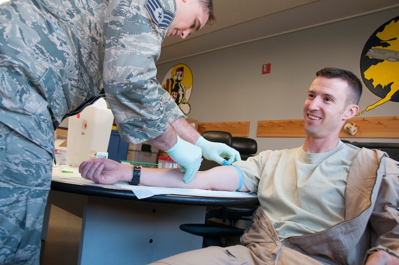 Staff Sgt. Brent Garrison, medical technician with the 168th Medical Group, Alaska Air National Guard, draws blood from the arm of Capt. John Goeres during in-processing procedures at the wing’s operations building October 16, 2016. The blood draw is a mandatory procedure for all returning service members, and is part of a post-deployment health assessment that is required by the Department of Defense. (U.S. Air National Guard photo by Senior Master Sgt. Paul Mann) 