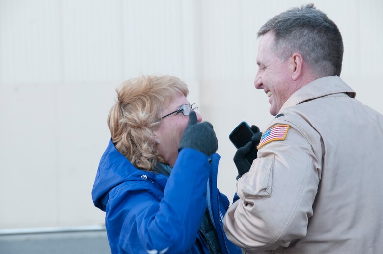 Lt. Col. Buck Smith is welcomed home for the last time by his wife Karyn just outside of the 168th Maintenance Group’s hanger at Eielson AFB, Alaska, October 16, 2016, where he and 33 other Airmen from the interior-Alaska Air Guard unit, were greeted by friends and family after they returned home from an extended deployment to Southwest Asia. This was the final deployment for Smith, who will be retiring from the 168th Wing in December 2016. (U.S. Air National Guard photo by Senior Master Sgt. Paul Mann/Released)