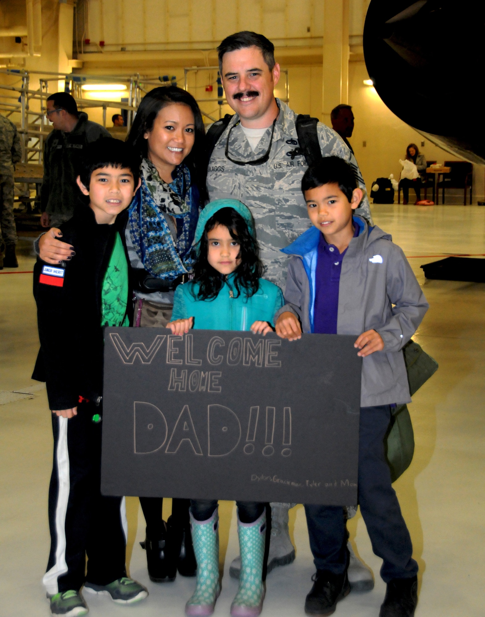 Master Sgt. Jeffrey Skaggs, fuels systems mechanic, poses with his family after being welcomed home from a two-month deployment to Southwest Asia, October 16, 2016. Skaggs’ family was among the crowd of observers who watched as two KC-135R aircraft from the 168th Wing landed on the flight line here at Eielson Air Force Base, Alaska, bringing home their loved ones. (U.S. Air National Guard photo by Airman 1st Class Mae S. Olson/Released)