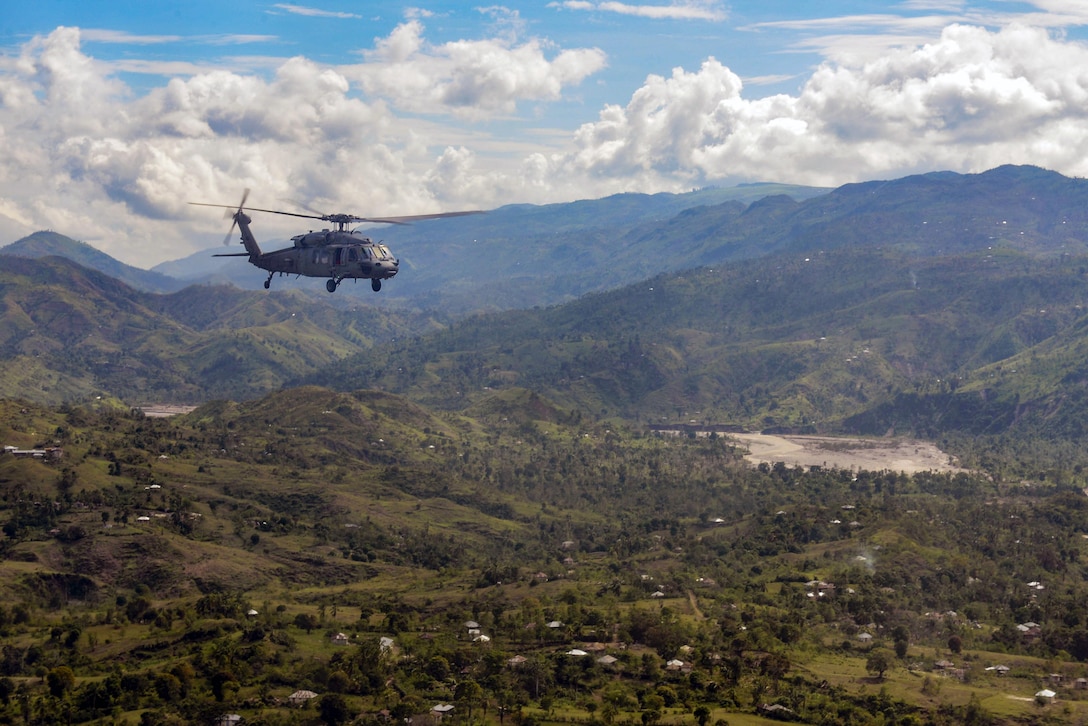 Sailors transport food in an MH-60S Knighthawk near Jabouin, Haiti, Oct. 18, 2016. The sailors are assigned to Joint Task Force Matthew, which provided disaster relief and humanitarian aid to Haiti following Hurricane Matthew. Navy photo by Petty Officer 2nd Class Hunter S. Harwell