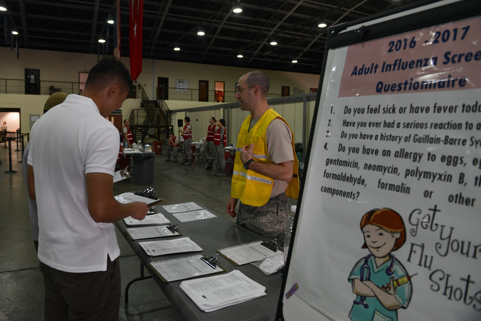 U.S. Air Force Tech. Sgt. James Dossett, 39th Medical Operations Squadron family health technician, greets Airmen and civilians as they come to get influenza vaccinations Oct. 15, 2016, at Incirlik Air Base, Turkey. All military personnel and civilians are required to get the annual influenza vaccination to prevent the virus from spreading during the upcoming flu season. (U.S. Air Force photo by Senior Airman Jasmonet Jackson)