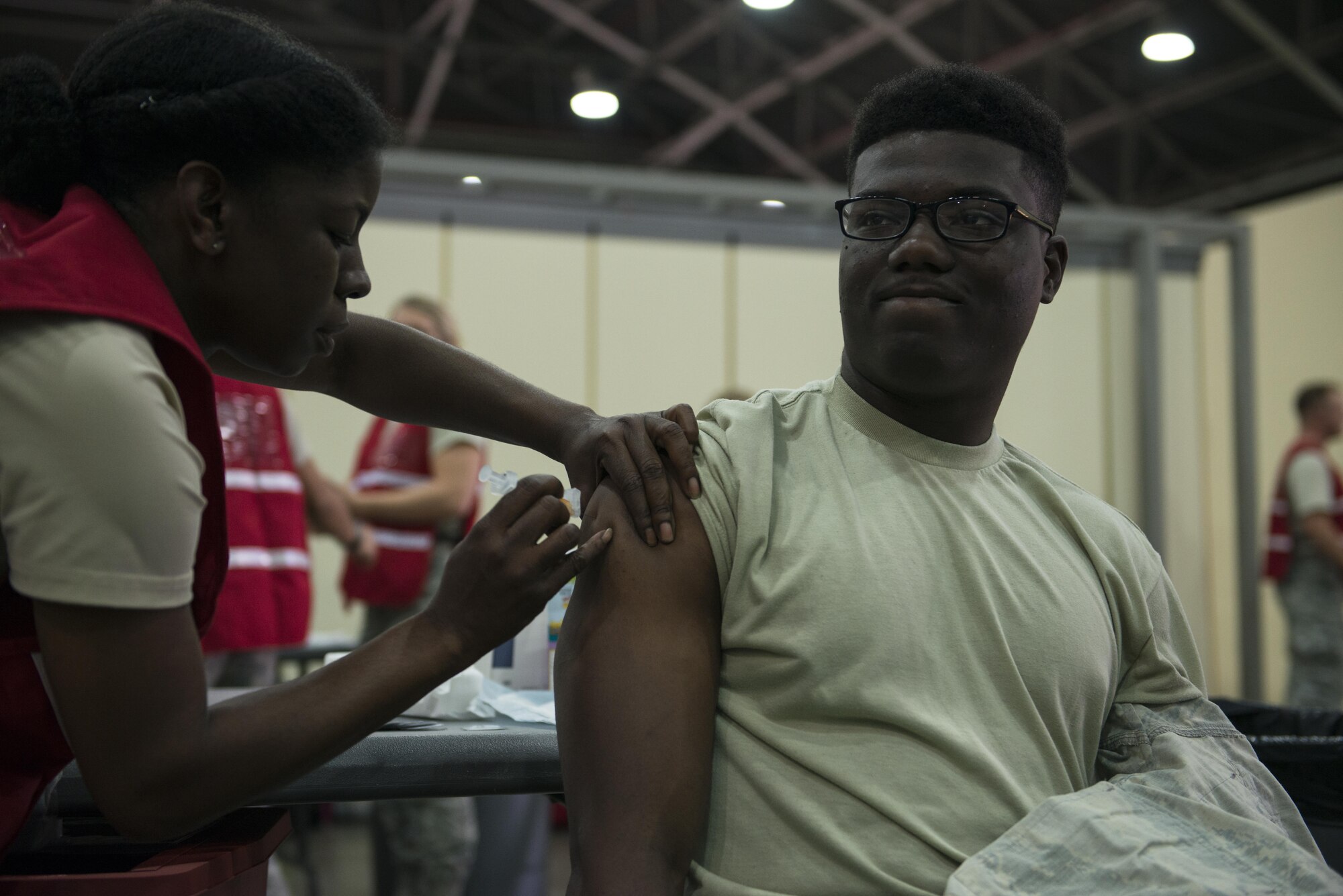 U.S. Air Force Tech. Sgt. Carmeilla Bethay, 39th Medical Operations Squadron clinical services flight chief, injects the influenza vaccine into Airman 1st Class James Gibson, 39th Security Forces Squadron Airman Oct. 15, 2016, at Incirlik Air Base, Turkey. Influenza vaccines are administered annually to all military personnel and civilians to prevent the spread of viruses in the upcoming flu season. (U.S. Air Force photo by Senior Airman Jasmonet Jackson)