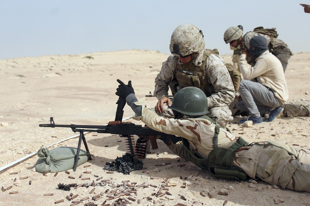 Cpl. Alexander Peebles, a team leader with Special Purpose Marine Air-Ground Task Force Crisis Response-Africa, demonstrates reloading techniques to a Mauritanian Fusiler Marin during a machine gun range near Rosso, Mauritania, Aug. 30, 2016. Marines worked on small unit tactics, detainee procedures, weapons handling and marksmanship techniques while training with the Mauritanian FUMA to aid in the suppression of illicit trafficking in the region.  (U.S. Marine Corps courtesy photo/released)