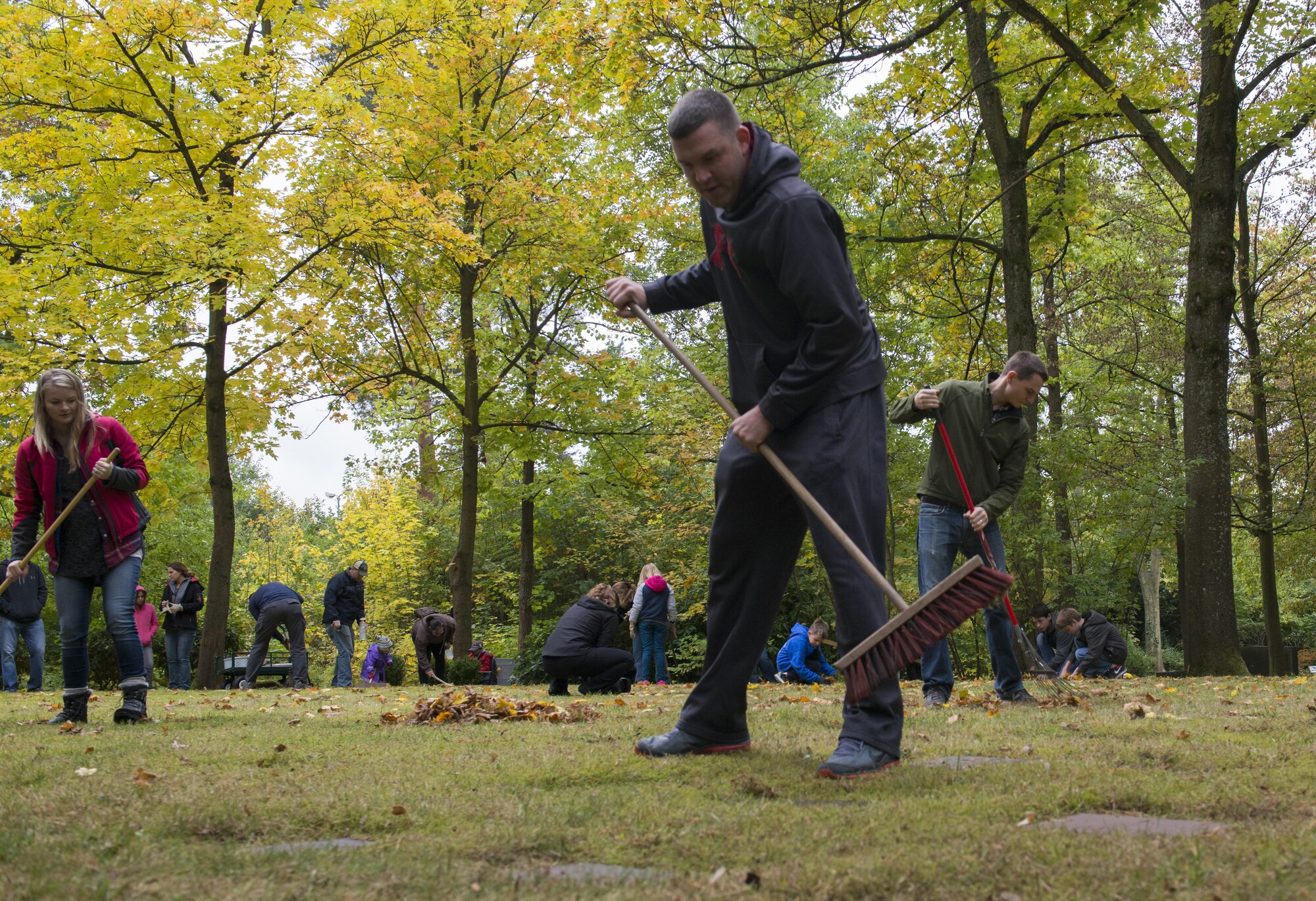 Members of the 86th Operations Support Squadron team clean the American Kindergraves in Kaiserslautern, Germany, Oct. 15, 2016. The Ramstein Area Chief’s Group organizes volunteers to clean the site once a month. (U.S. Air Force photo by Senior Airman Tryphena Mayhugh)