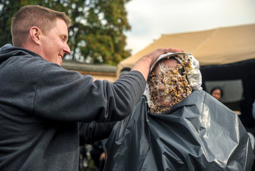 Maj. Reed Reichwald, 693rd Intelligence, Surveillance and Reconnaissance Group operational psychologist, spreads a “mutton” pie over the head of Lt. Col. Ariel Batungbacal, 450th Intelligence Squadron commander, during the Pie-in-the-Face portion of the 693rd ISRG’s 5th Annual Highland Games in Wiesbaden, Germany, Oct. 14, 2016. Members of the 693rd ISRG donated money to have other members of the group hit in the face with a pie. All proceeds raised for the event were donated to the Combined Federal Campaign-Overseas. (U.S. Air Force photo by Staff Sgt. Timothy Moore)