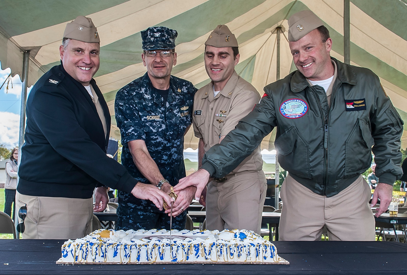 (From left) Navy Capt. Justin DeBord, Navy Capt. Jeffrey Schmidt, Lt. Cmdr. Michael Sargent, and Navy Capt. Brian Ginnane slice the cake at the Navy's 241st birthday celebration Oct. 13 at Defense Supply Center Columbus. Schmidt and Sargent represented the oldest and youngest, respectively, sailors in attendance.
