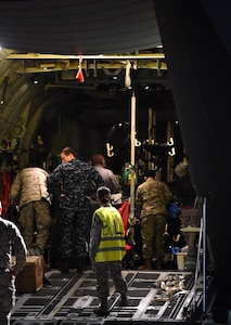 Senior Airman Arlinda Haliti, a medic with the 559th Medical Group En-Route Patient Staging System team, looks on as the 59th Medical Wing’s Acute Lung Rescue Team preps a patient for transport at Kelly Airfield, Joint Base San Antonio-Lackland, Texas, Oct. 15, 2016. The patient, a Navy Sailor, was flown onboard a C-130J Super Hercules from the Navy Medical Center in San Diego to San Antonio for treatment at the San Antonio Military Medical Center in nearby JBSA-Fort Sam Houston. The Acute Lung Rescue Team medics tended to the patient for the duration of the flight. (U.S. Air Force photo/Staff Sgt. Jerilyn Quintanilla)