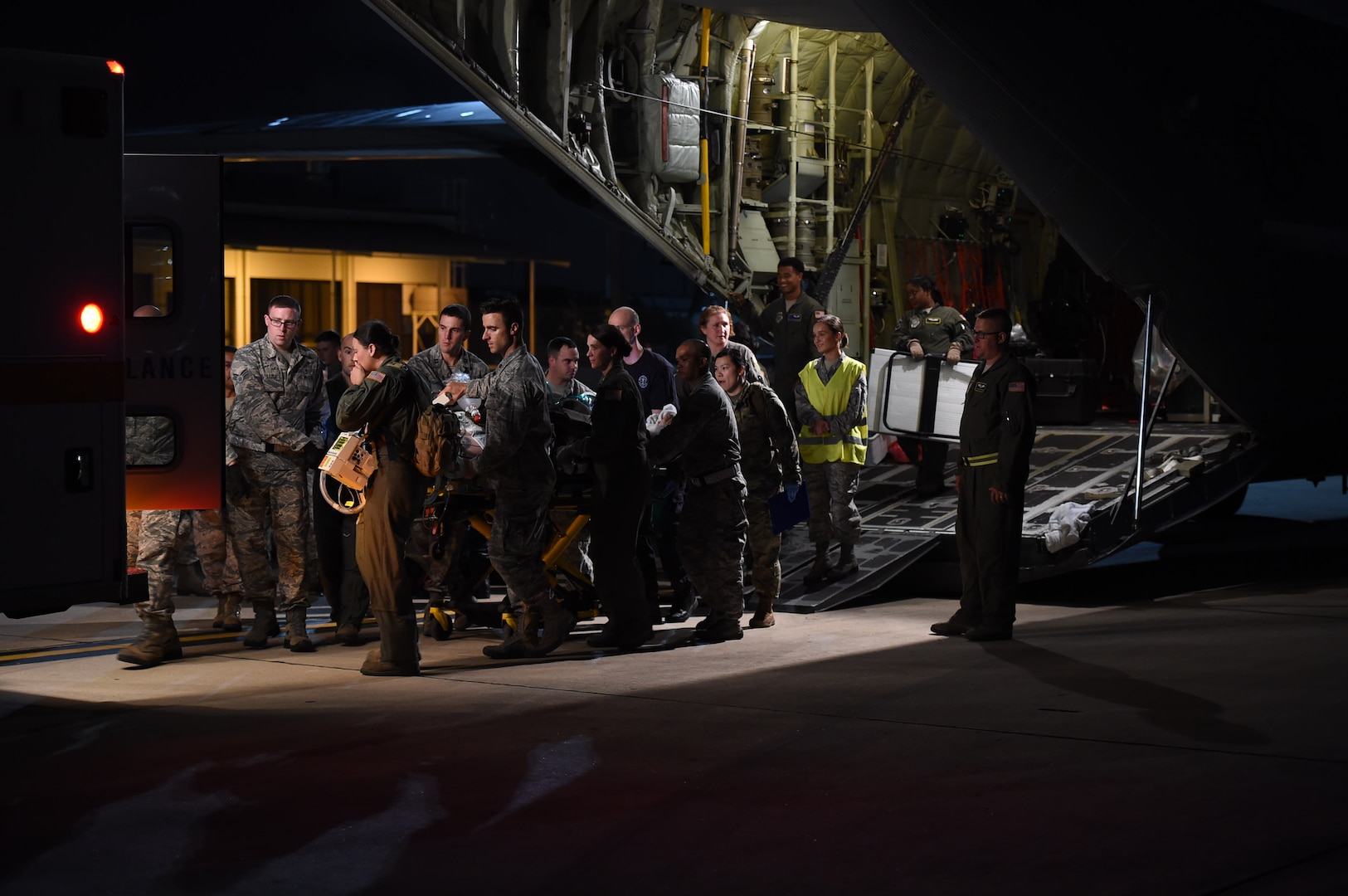 Members of the 59th Medical Wing’s En-Route Patient Staging System, emergency medical services and Acute Lung Rescue Team transport a patient from a C-130J Super Hercules to an ambulance at Kelly Airfield, Joint Base San Antonio-Lackland, Texas, Oct. 15, 2016. The teams each played an integral part in safely moving the patient, a Navy Sailor, from the Navy Medical Center in San Diego to the San Antonio Military Medical Center at nearby Joint Base San Antonio-Fort Sam Houston, for care. (U.S. Air Force photo/Staff Sgt. Jerilyn Quintanilla)