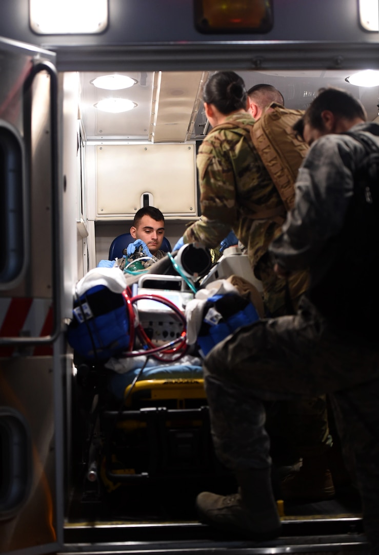 Senior Airman Dominick Espinoza, a 559th Medical Group En-Route Patient Staging System team medic, assists the 59th Medical Wing’s Acute Lung Rescue Team as they tend to a patient at Kelly Airfield, Joint Base San Antonio-Lackland, Texas, Oct. 15, 2016. The patient was flown aboard a C-130J Super Hercules from the Navy Medical Center in San Diego to San Antonio for treatment at the San Antonio Military Medical Center. (U.S. Air Force photo/Staff Sgt. Jerilyn Quintanilla)