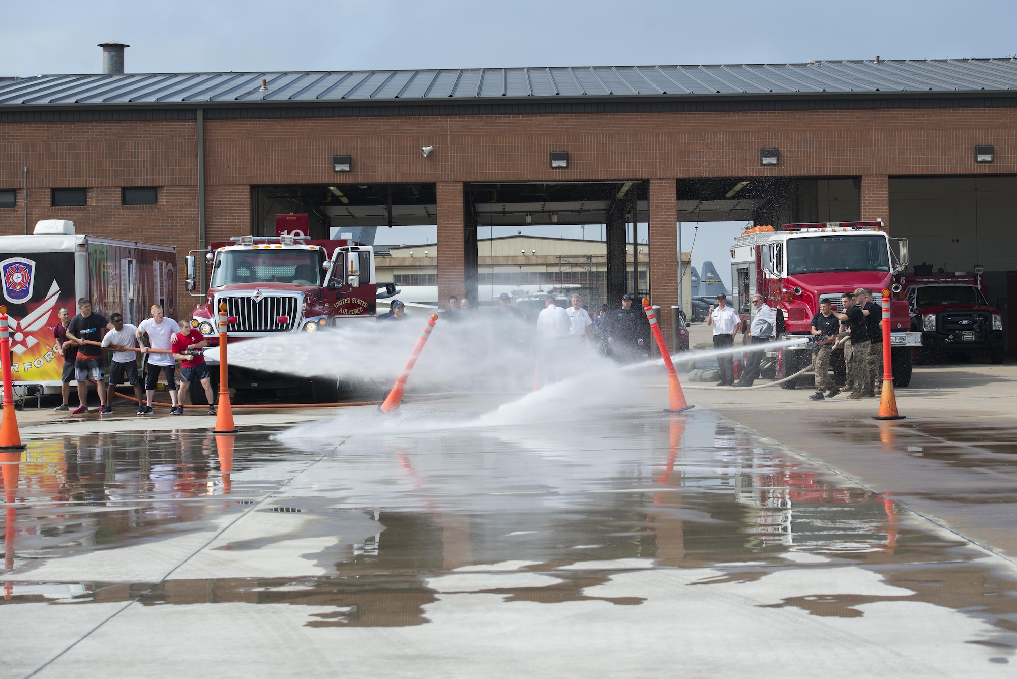 A team of Airmen from the 82nd Medical Group and the 82nd Security Forces Squadron, compete head-to-head in the Sheppard Air Force Base, firefighter challenge, Oct. 14, 2016. Each team had to knock over the cones in their lanes with the fire hose in-order to progress to the next challenge. (U.S. Air Force photo by Senior Airman Kyle E. Gese)