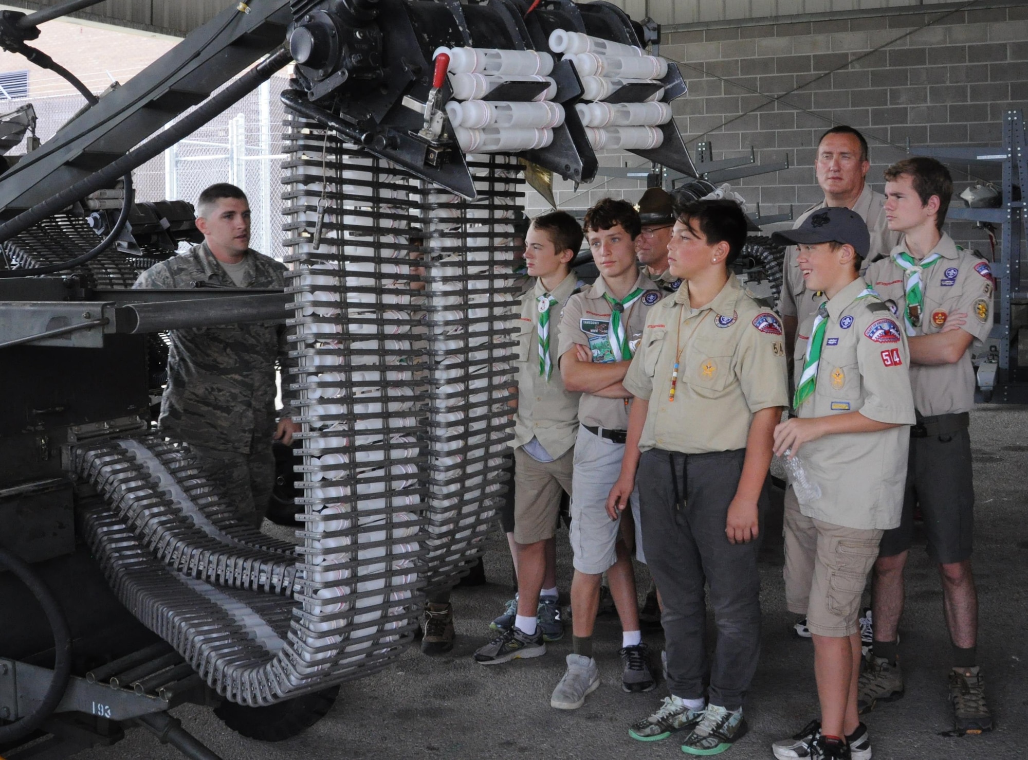 Boy Scouts from Lee's Summit Troop 54 observe U.S. Air Force Tech. Sgt. James Register, 442nd Aircraft Maintenance Squadron weapons flight technician, as he demonstrates the armament process for the A-10 Thunderbolt II's GAU-8/A 30mm cannon at Whiteman Air Force Base, Mo., Oct. 15, 2016. The troop traveled approximately 50 minutes to camp at Knob Noster State Park and tour the nearby 442nd Fighter Wing at Whiteman. (U.S. Air Force photo/Senior Airman Missy Sterling)